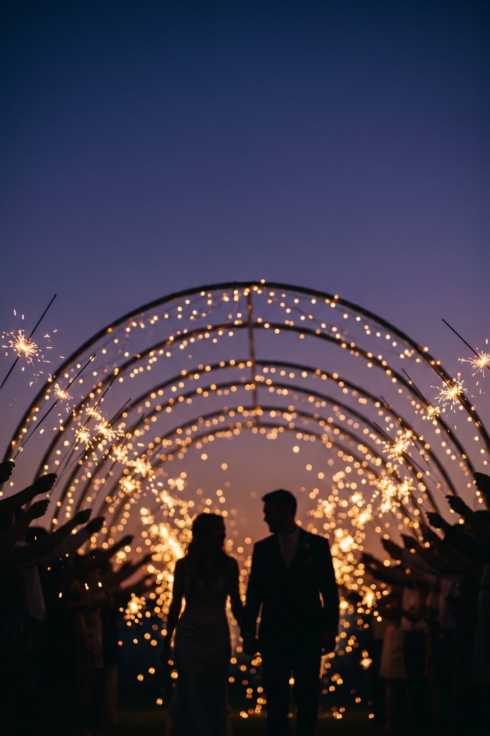 Wedding sparkler send-off photo at golden hour